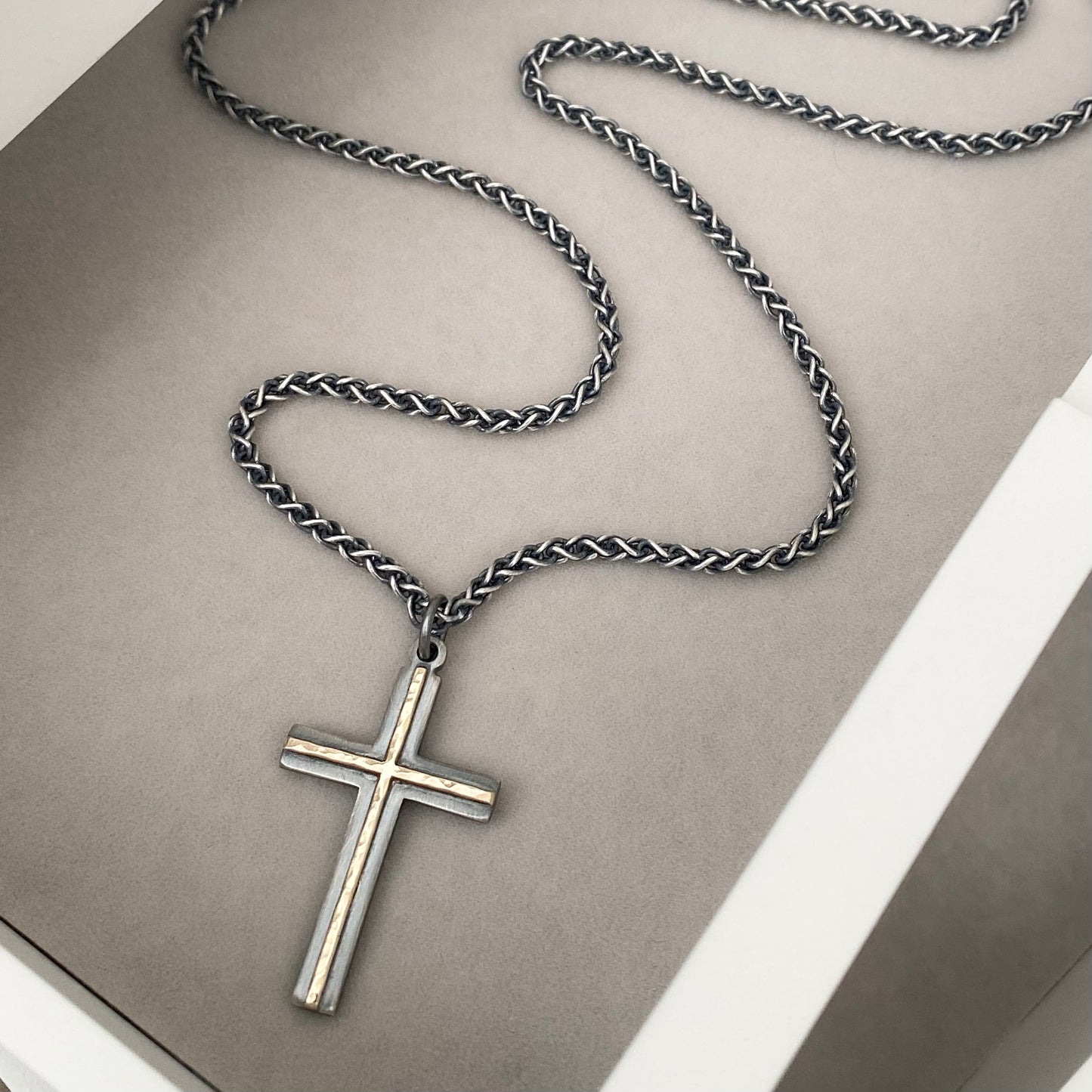 Oxidised solid sterling silver and hammered 9ct yellow gold medium cross pendant on an oxidised silver spiga chain