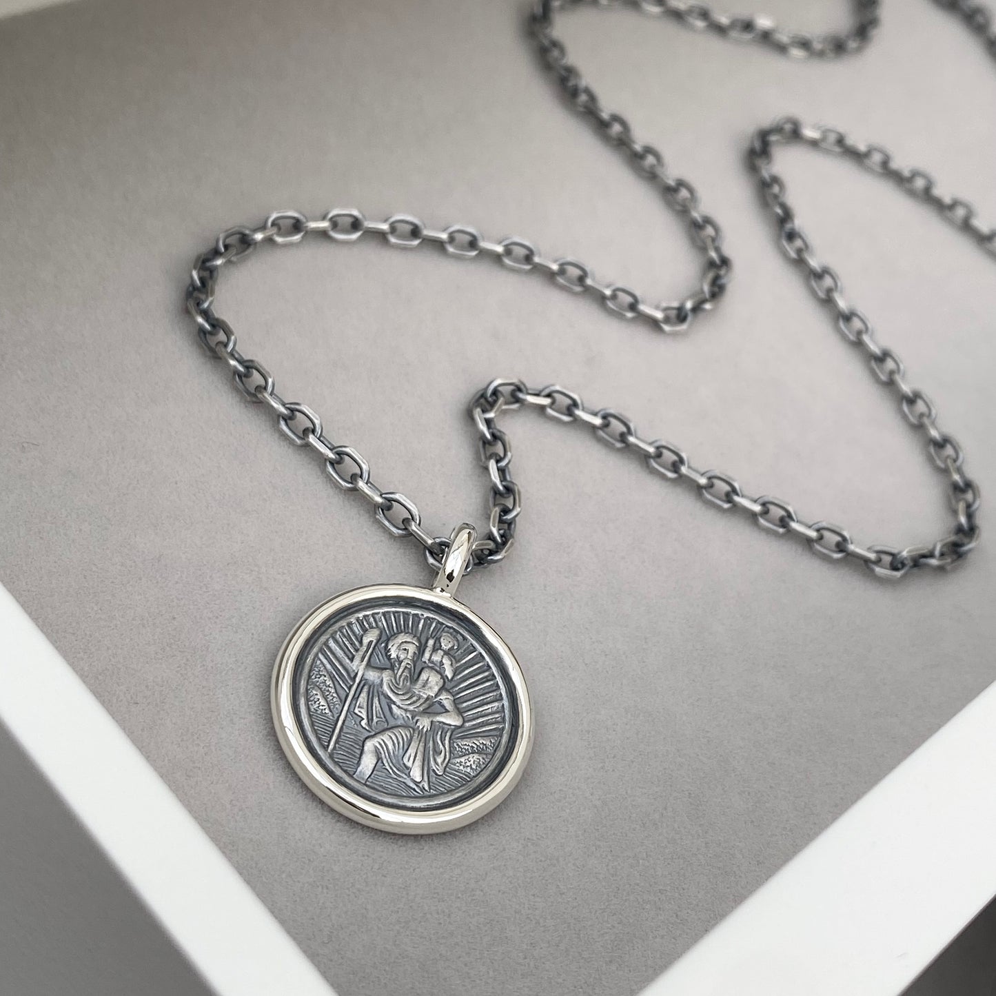 Oxidised solid silver Saint Christopher circle framed pendant on a 2.9mm wide diamond cut trace chain