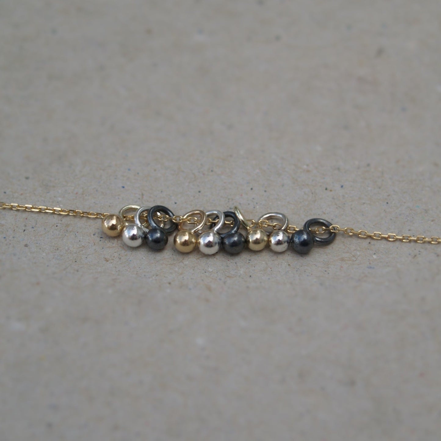 9ct solid yellow gold, silver and oxidised silver tiny seed ball pendants on a 9ct yellow gold chain