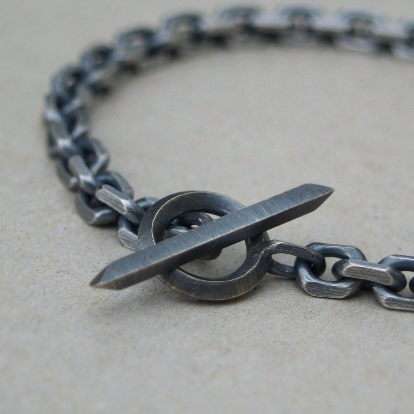 Oxidised or polished solid silver 6.6mm wide diamond cut trace chain bracelet with a unique T-bar design