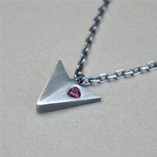 Oxidised solid sterling silver large arrow pendant set with a rhodolite garnet heart on a diamond cut trace chain