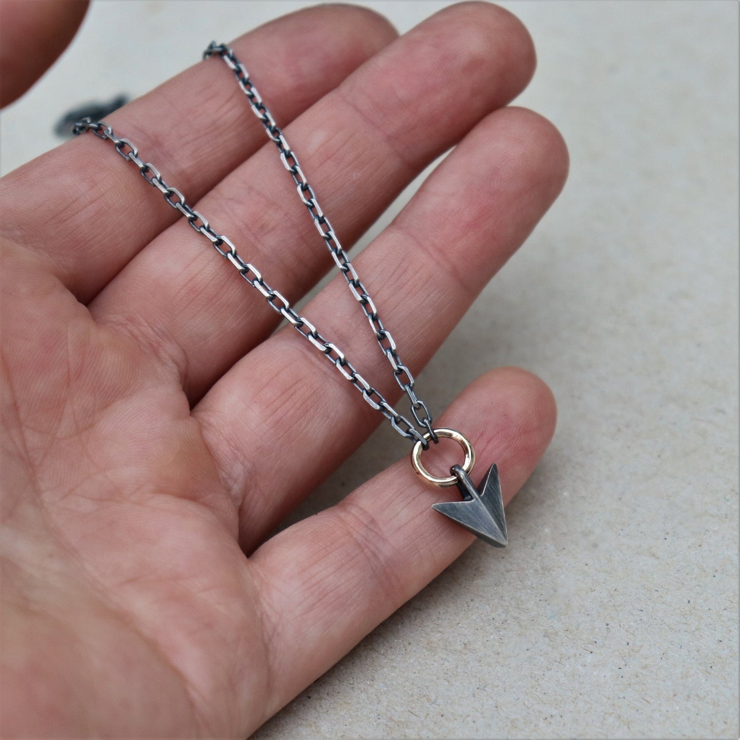 Oxidised or polished solid silver arrow pendant and 9ct yellow gold loop detail on a diamond cut trace chain