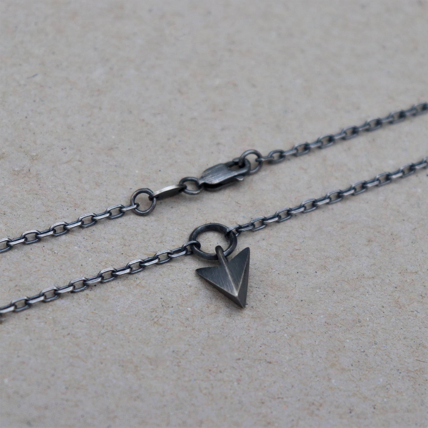 Solid silver arrow loop detail pendant on a diamond cut trace chain - Oxidised or polished