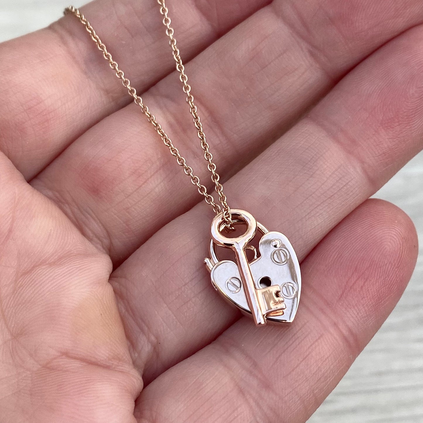 9ct solid rose gold heart padlock and small key charm pendants on a trace chain