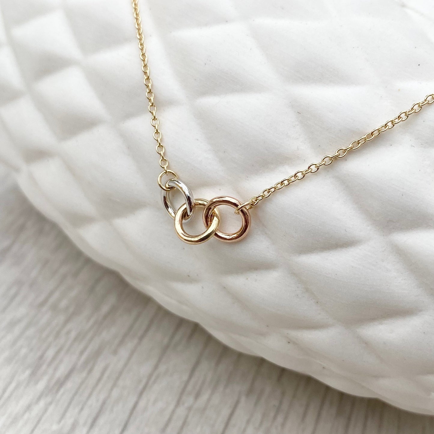 9ct solid yellow, white and rose gold three linked rings necklace with a 9ct yellow gold trace chain