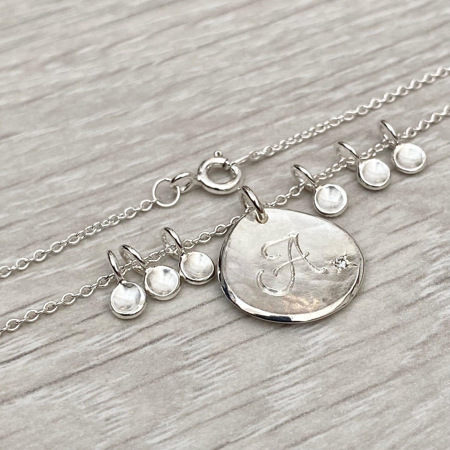 Handmade personalised solid silver 16mm diamond petal charm pendants on a trace chain