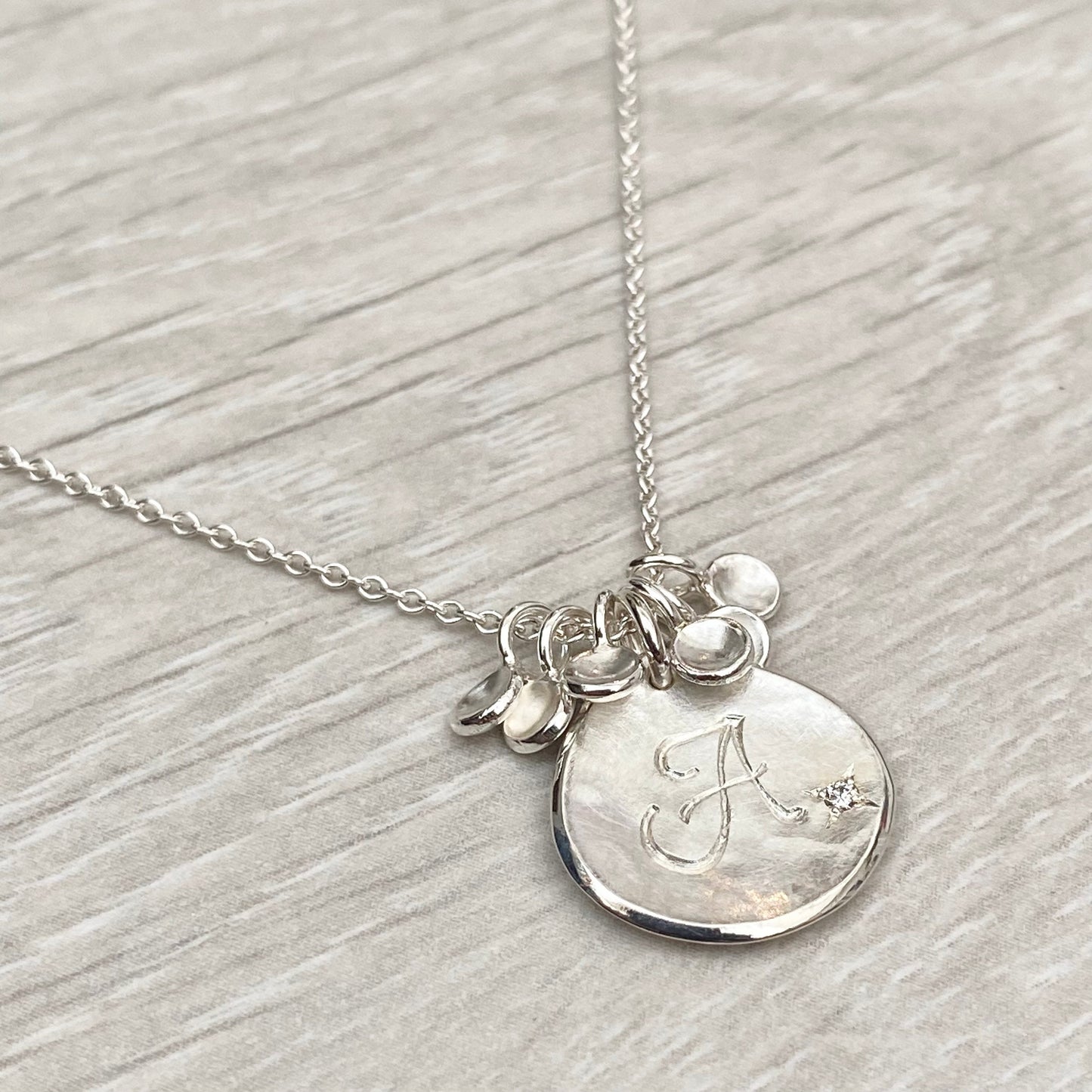 Handmade personalised solid silver 16mm diamond petal charm pendants on a trace chain