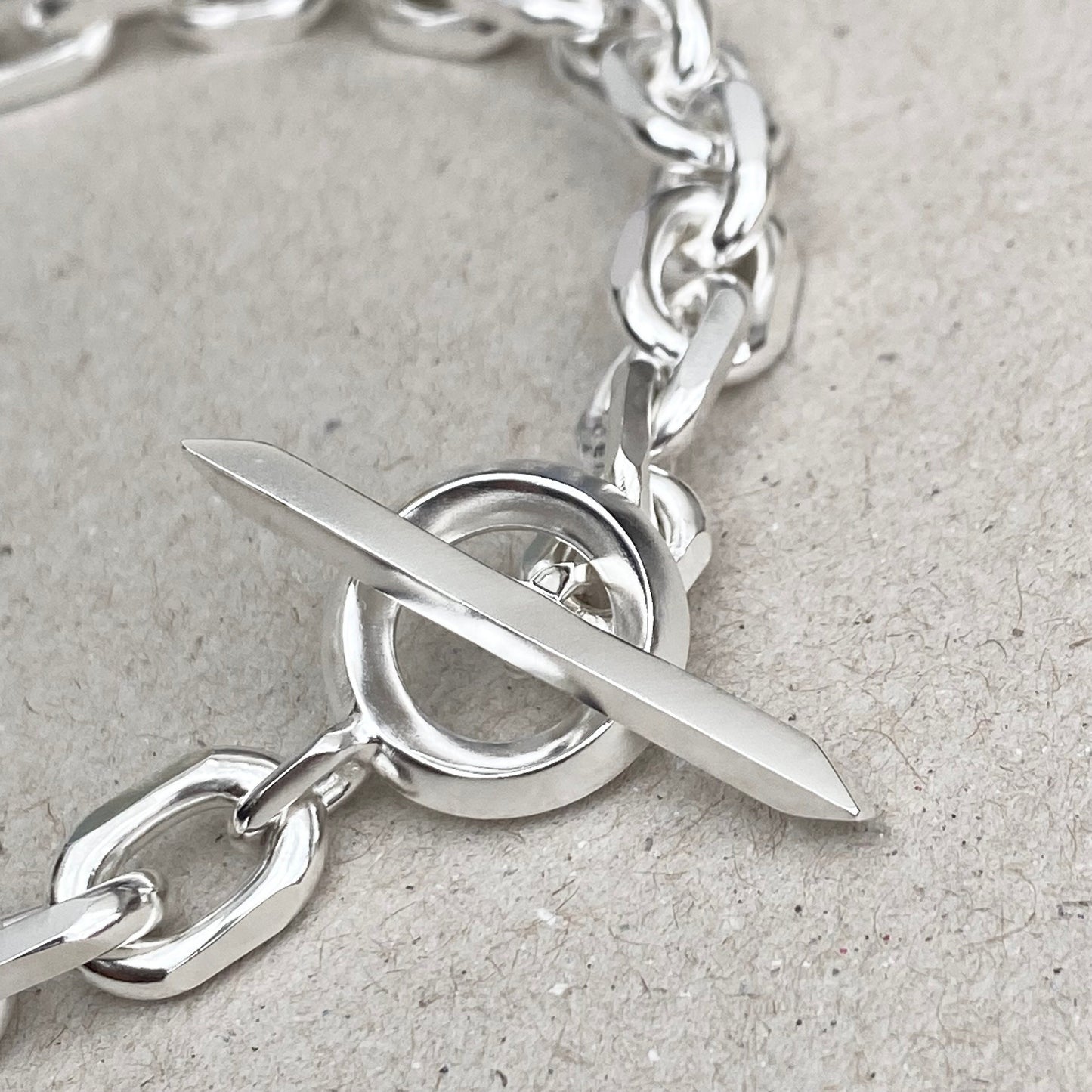 Oxidised or polished solid silver 8.5mm wide diamond cut trace chain bracelet with a unique T-bar design