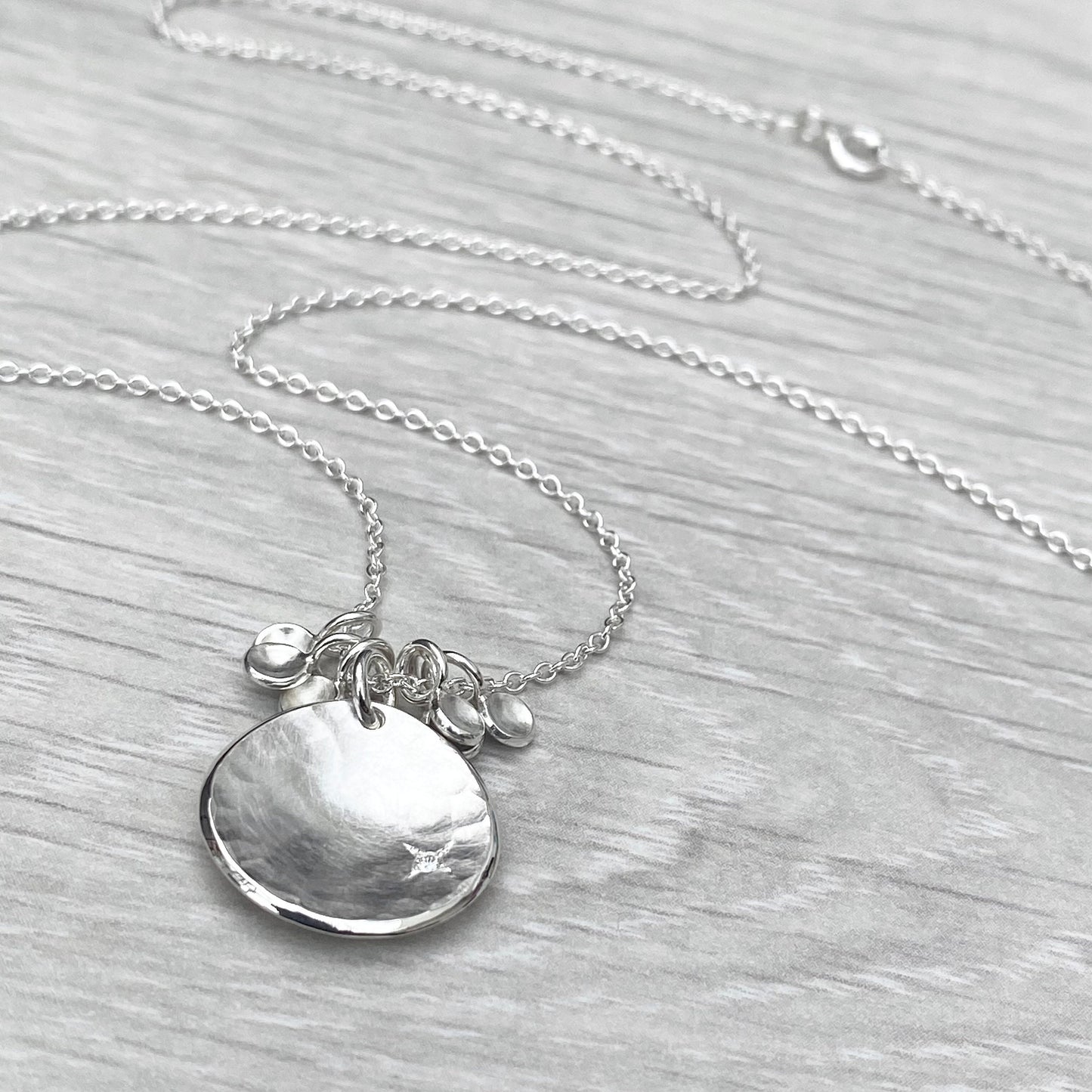 Handmade solid silver 16mm diamond kiss petal charm pendants on a trace chain