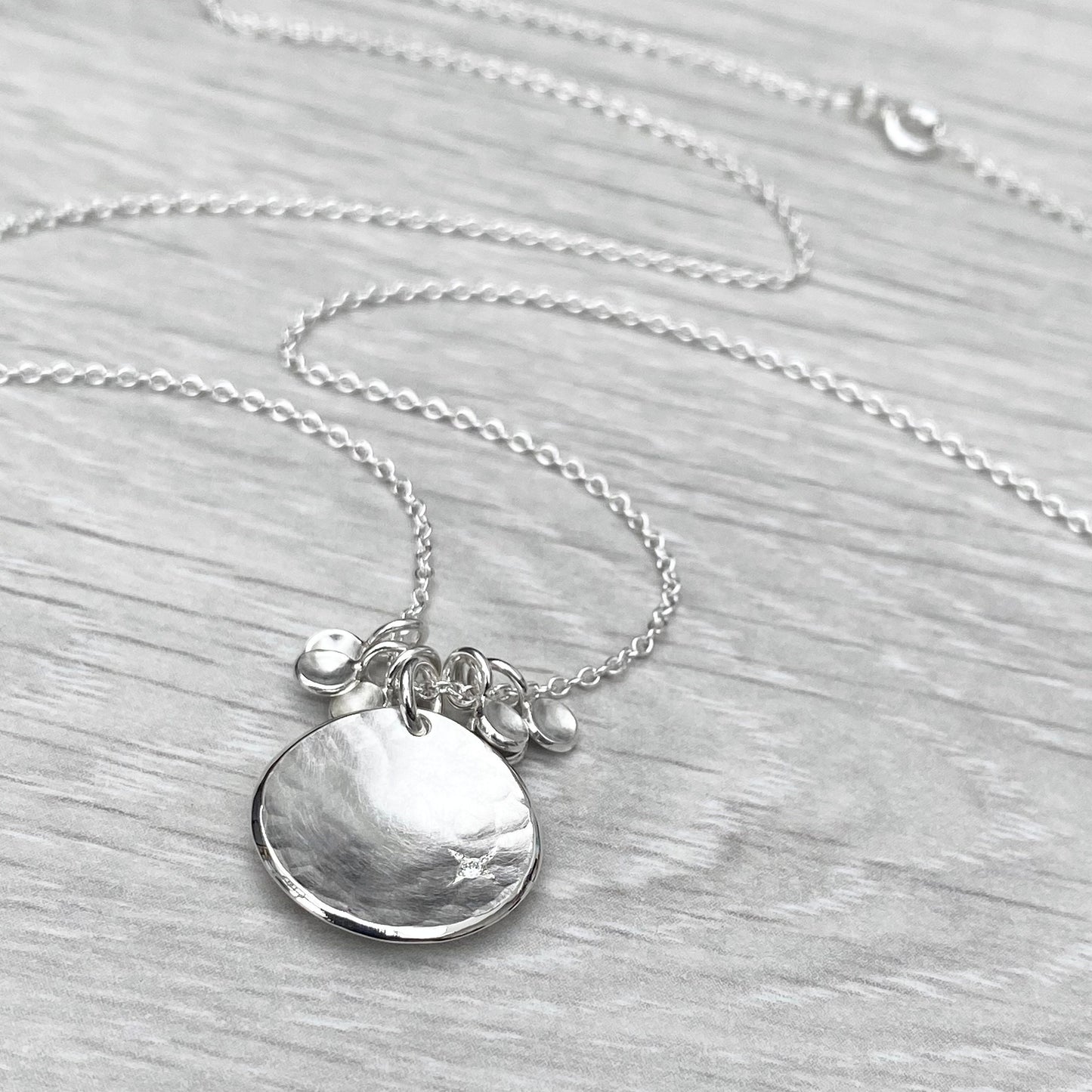 Handmade solid silver 16mm diamond kiss petal charm pendants on a trace chain