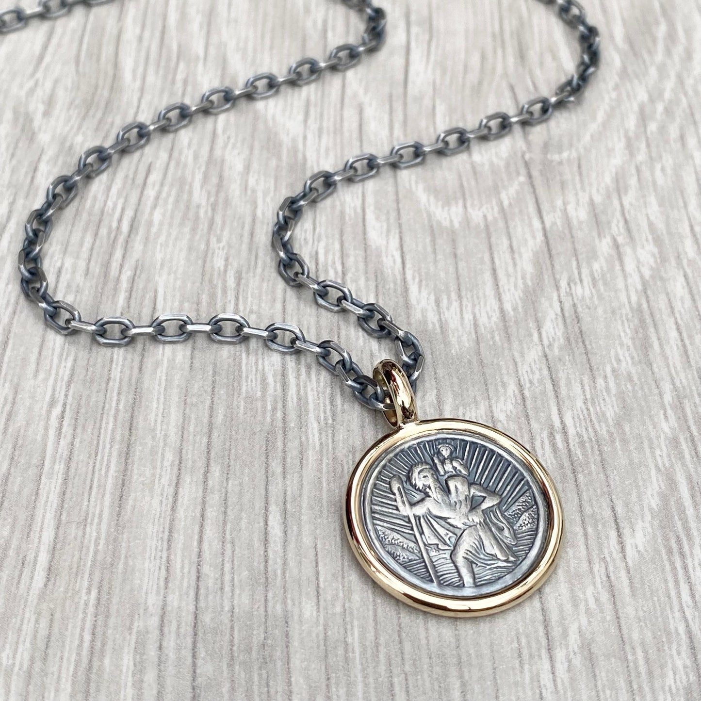 Oxidised solid silver round Saint Christopher 9ct yellow gold framed pendant on diamond cut trace chain