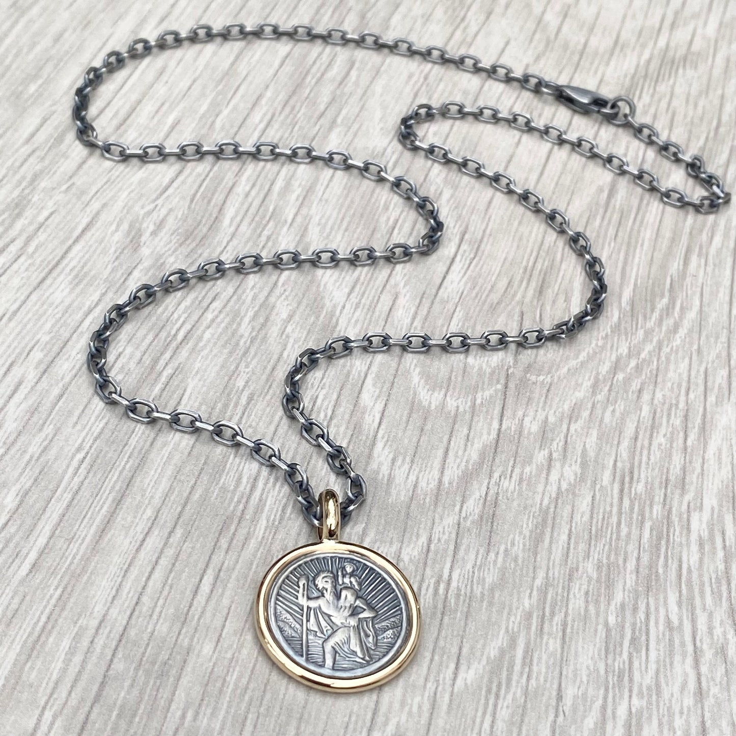 Oxidised solid silver round Saint Christopher 9ct yellow gold framed pendant on diamond cut trace chain