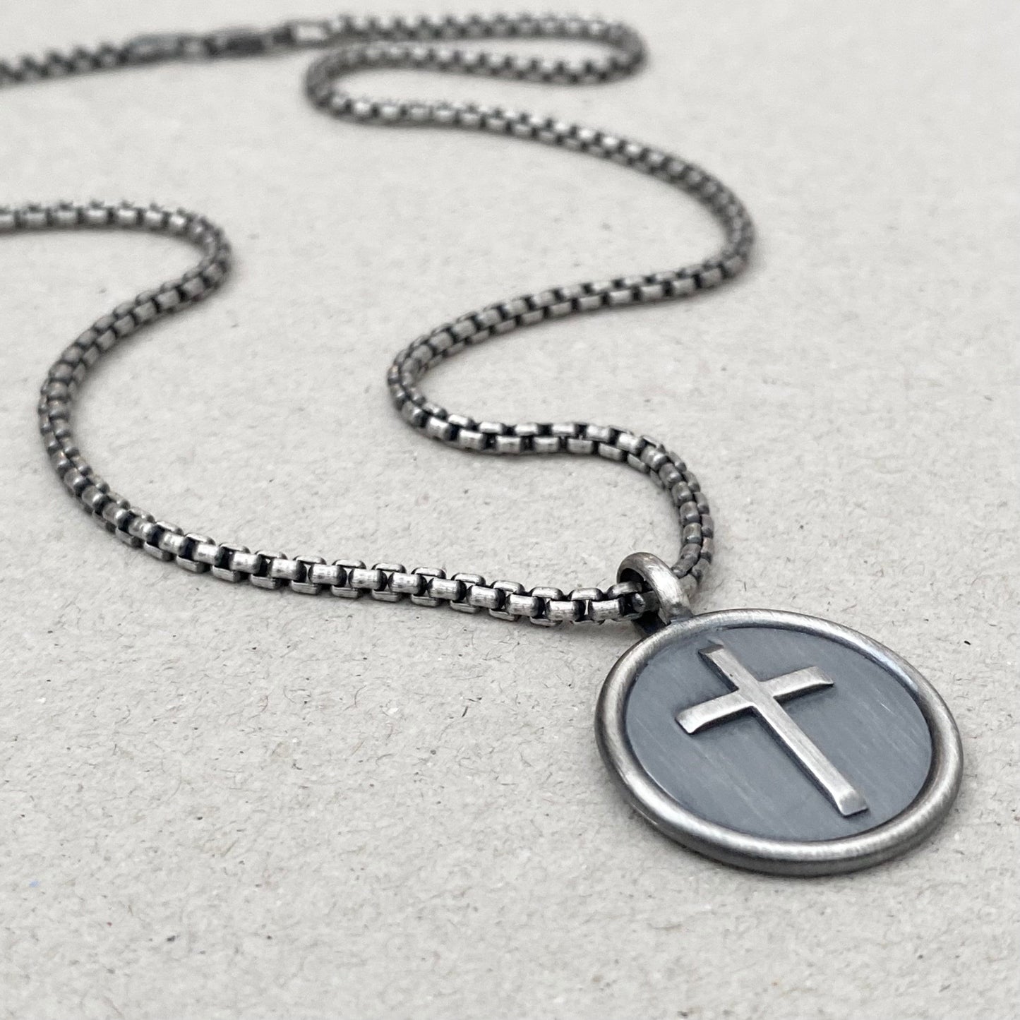Oxidised solid sterling silver framed circle cross pendant on a box belcher chain