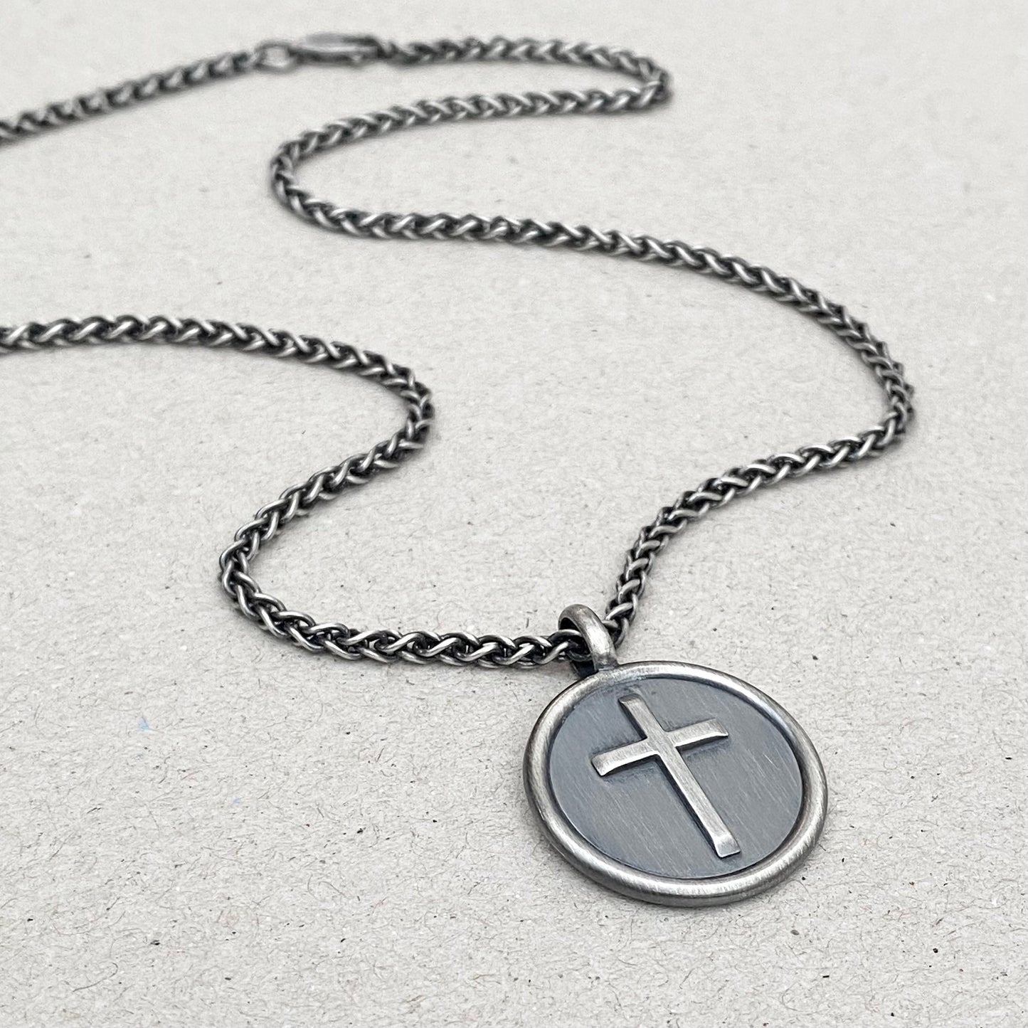Oxidised solid sterling silver framed circle cross pendant on a spiga chain