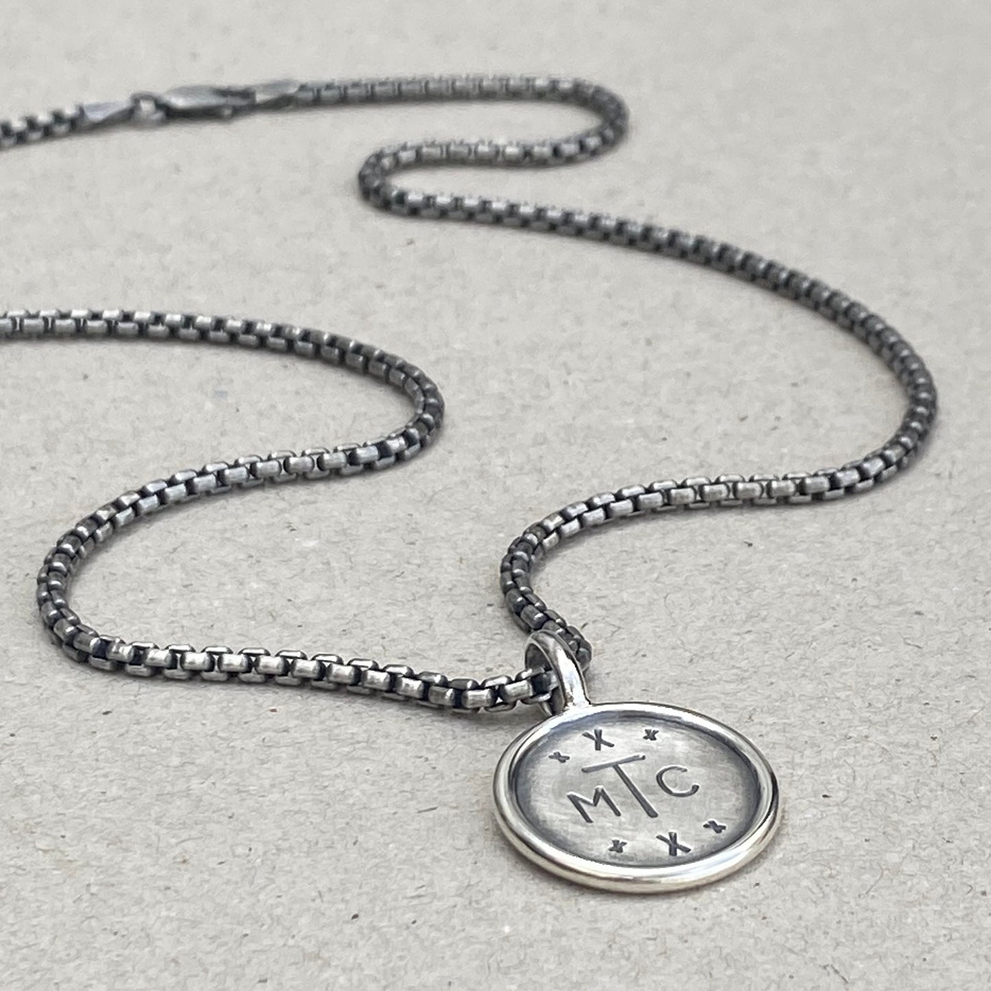 Handmade oxidised solid sterling silver round framed initial pendant on a round box belcher chain
