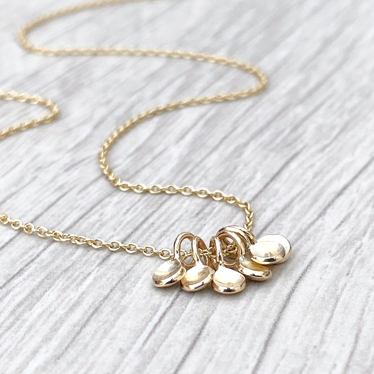 Handmade 9ct yellow gold six tiny petal charm pendants on a trace chain