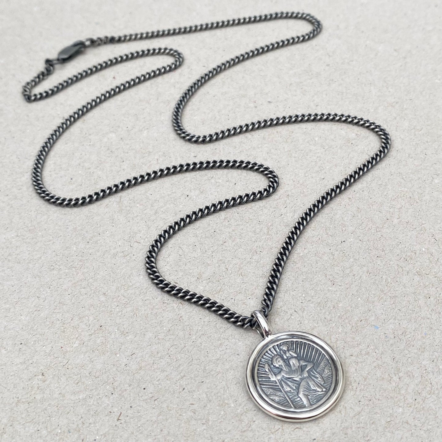 Oxidised solid silver Saint Christopher circle framed pendant on a close curb chain