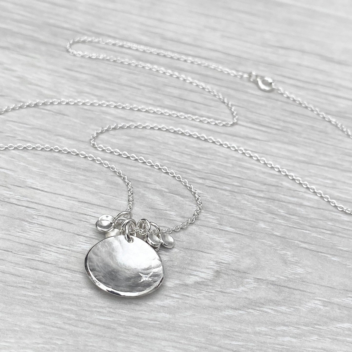 Handmade solid silver 16mm diamond kiss petal charm pendants on a trace chain