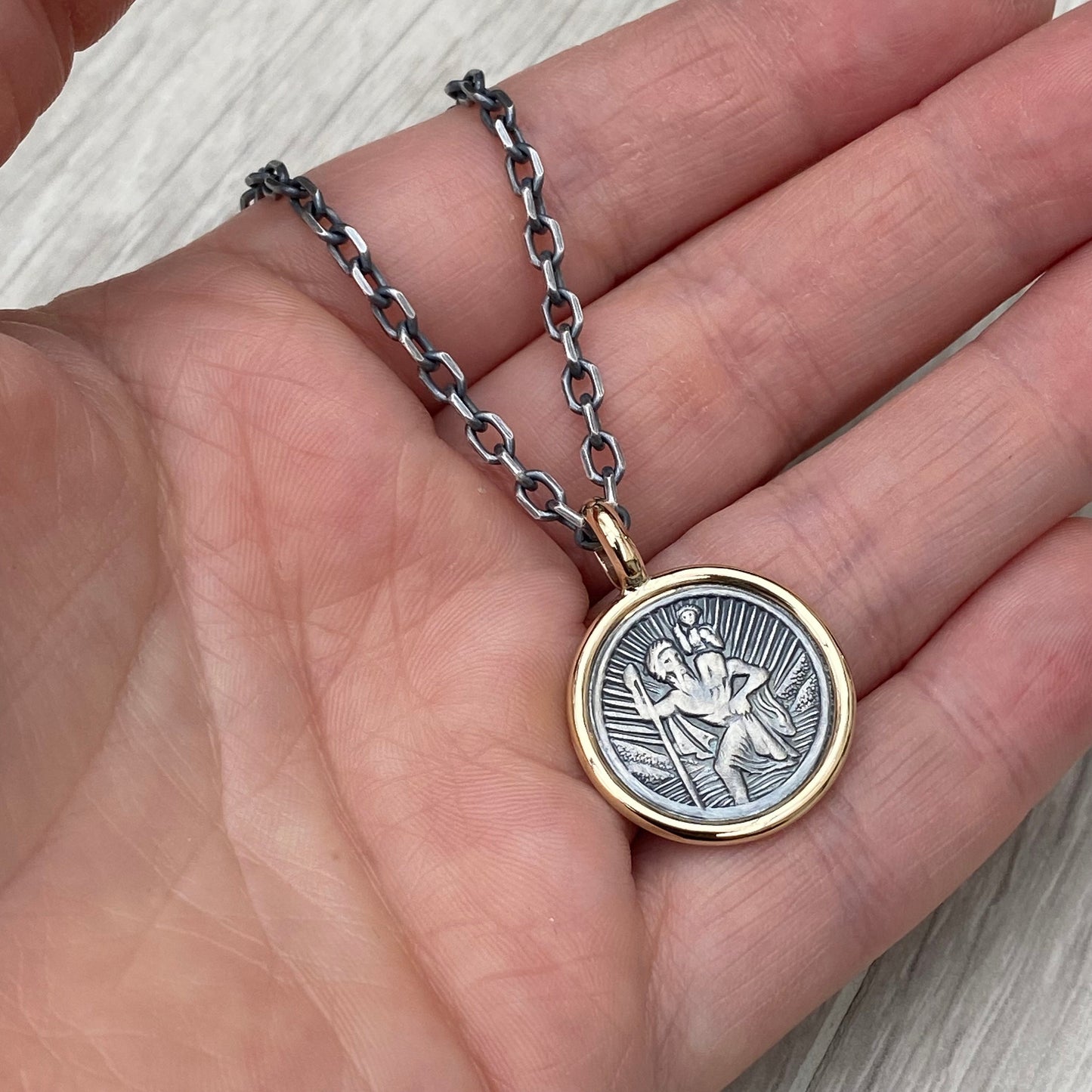 Oxidised solid silver round Saint Christopher 9ct yellow gold framed pendant on diamond cut trace chain