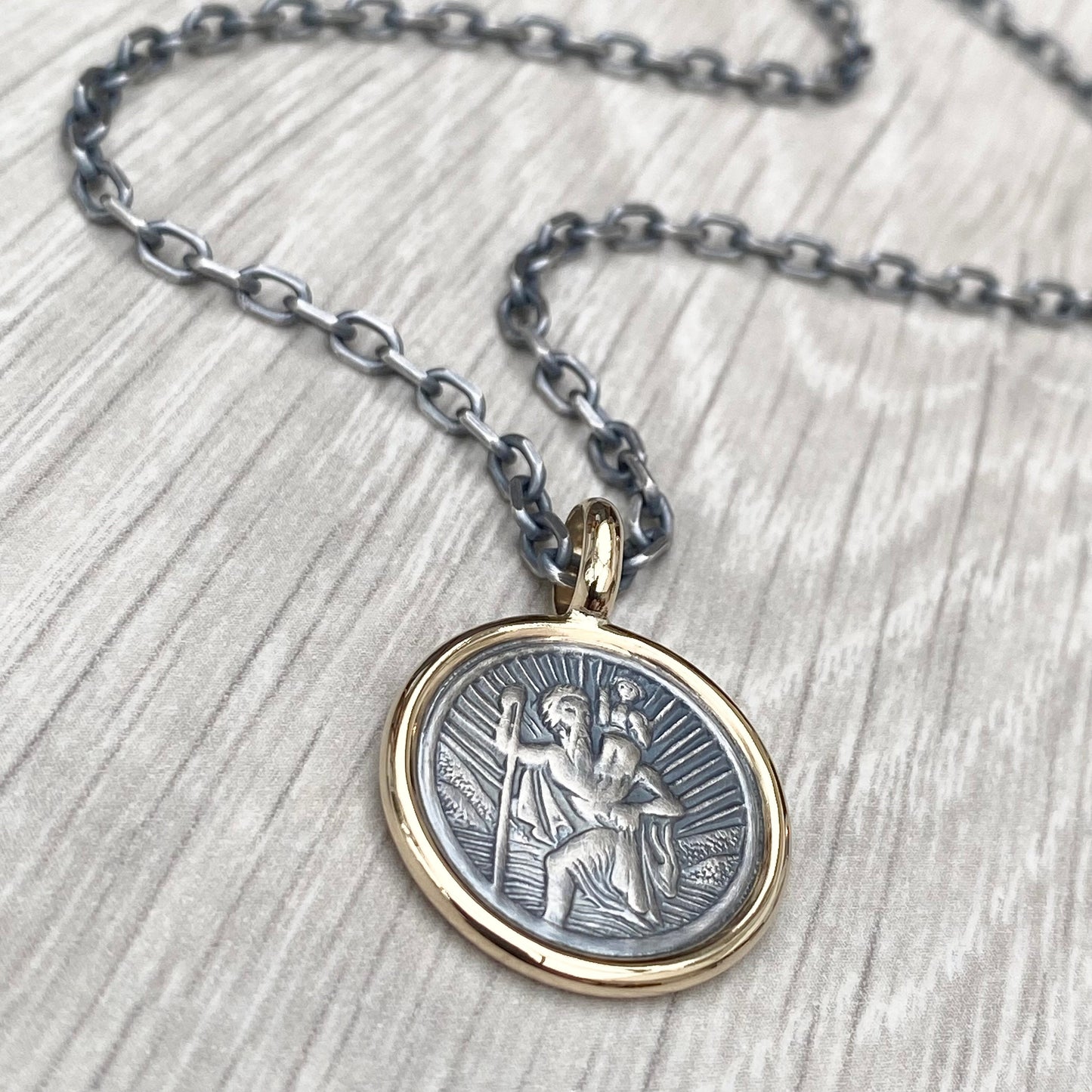Oxidised solid silver round Saint Christopher 9ct yellow gold framed pendant on diamond cut trace chain