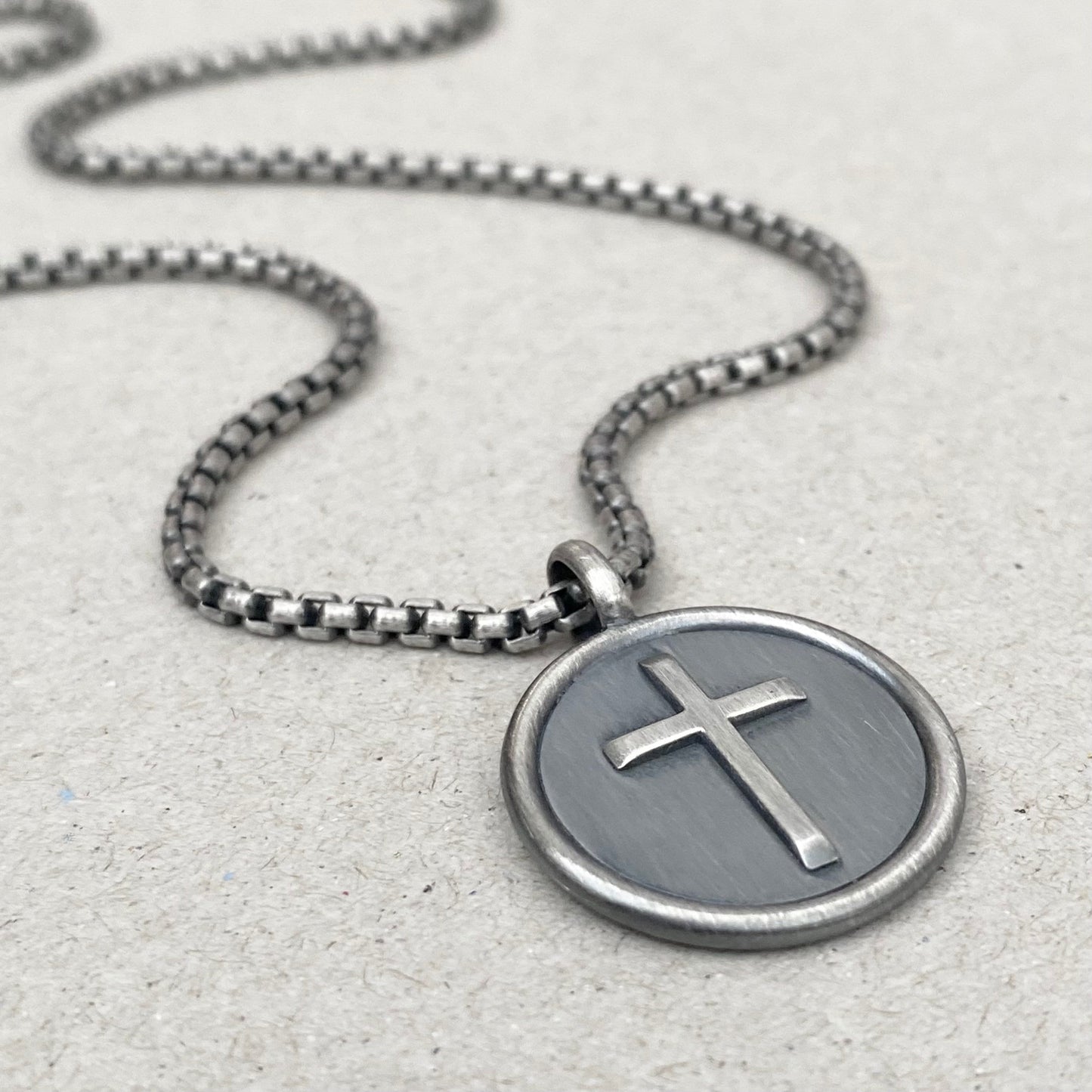 Oxidised solid sterling silver framed circle cross pendant on a box belcher chain