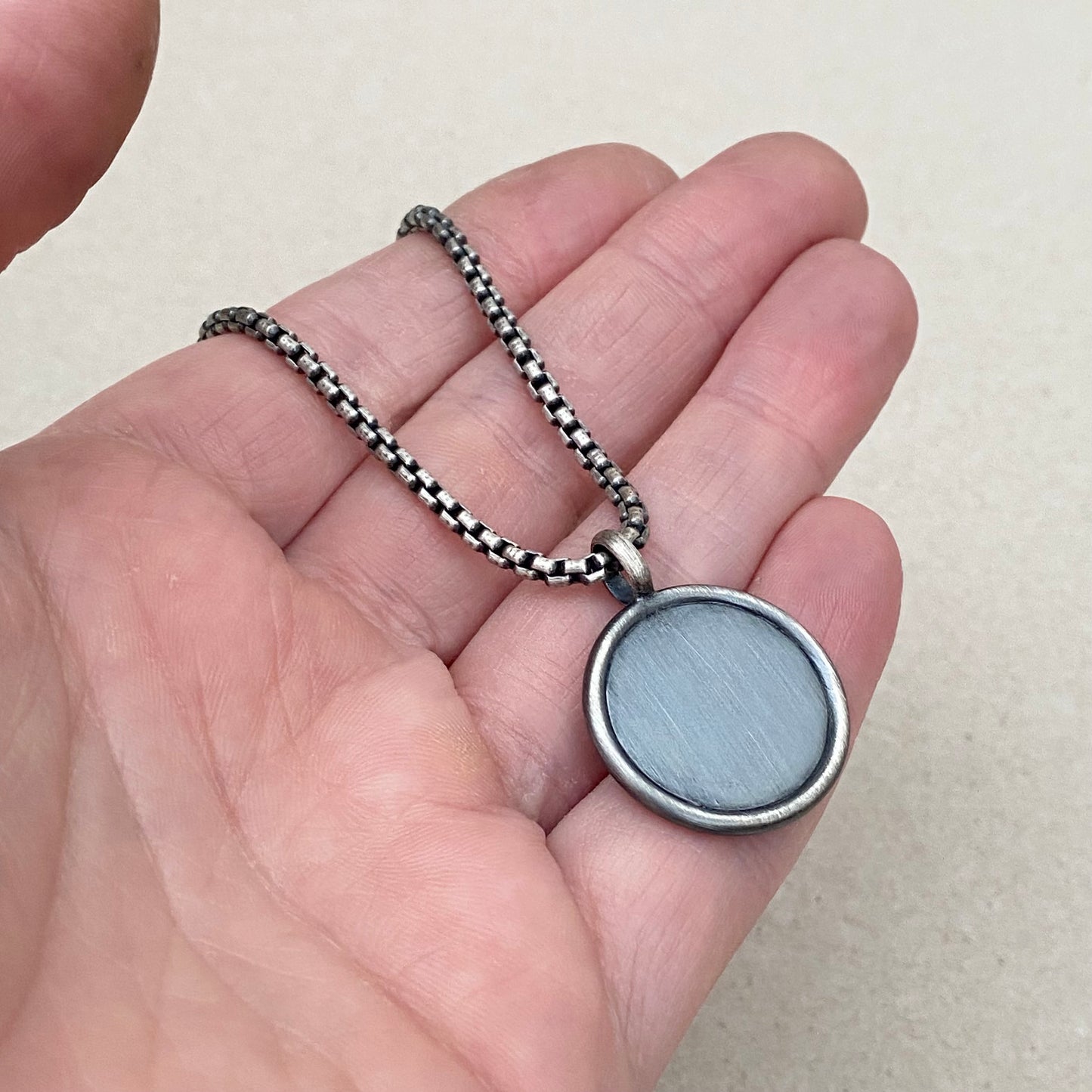 Oxidised solid sterling silver framed circle cross pendant on a box belcher chain