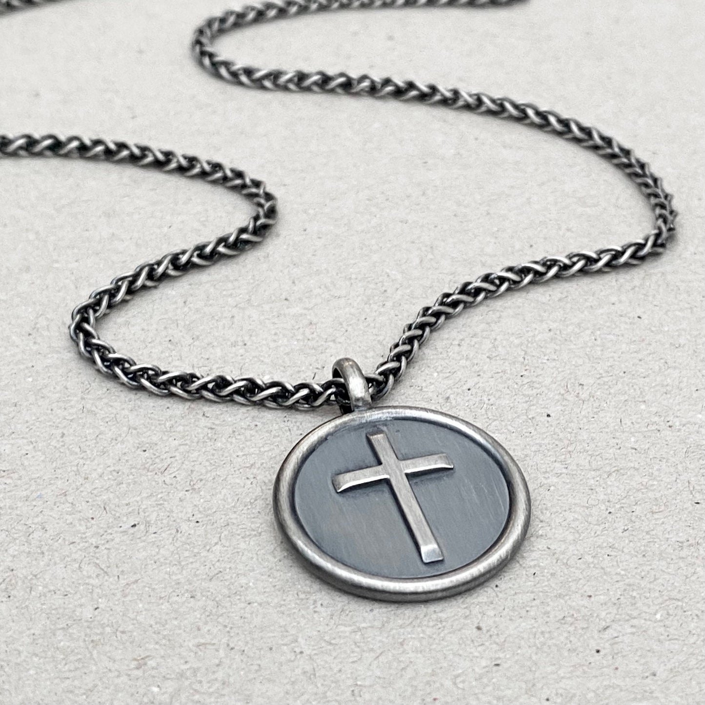 Oxidised solid sterling silver framed circle cross pendant on a spiga chain