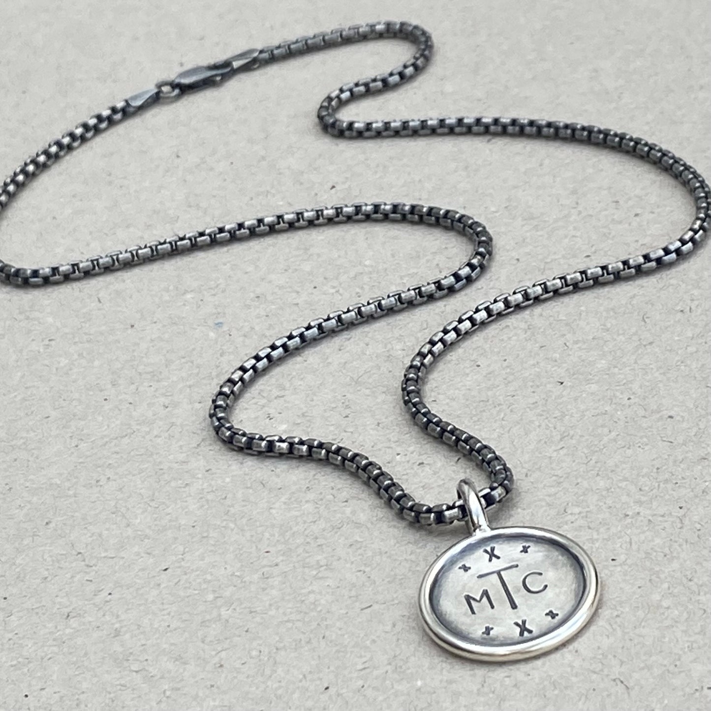 Handmade oxidised solid sterling silver round framed initial pendant on a round box belcher chain