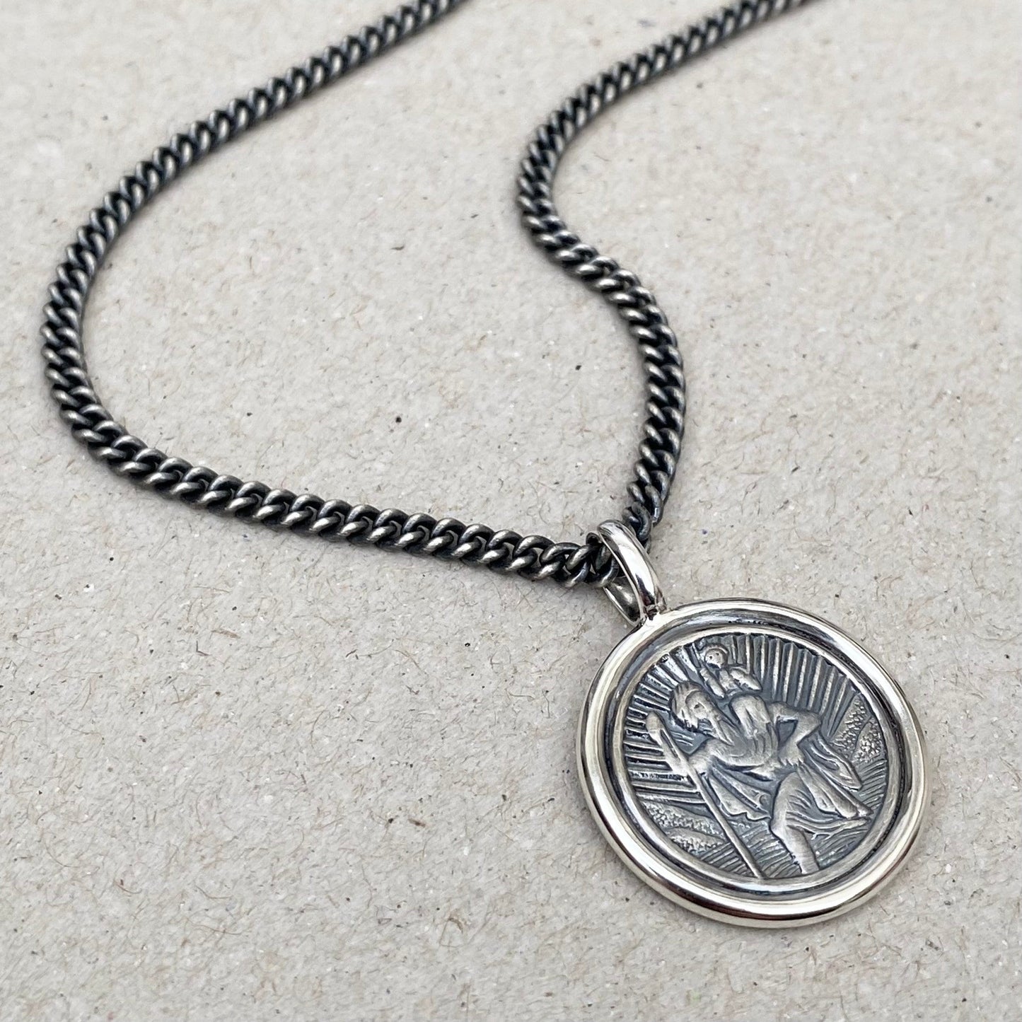 Oxidised solid silver Saint Christopher circle framed pendant on a close curb chain
