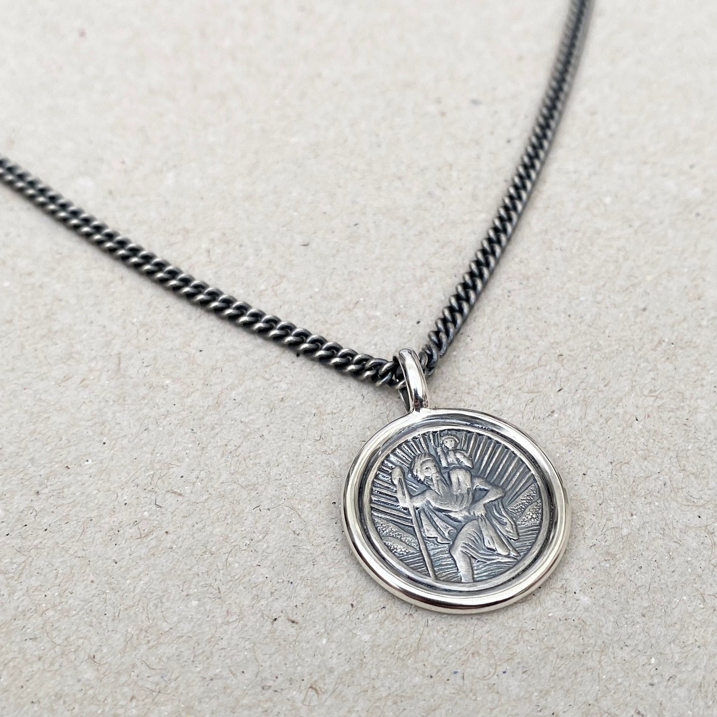 Oxidised solid silver Saint Christopher circle framed pendant on a close curb chain