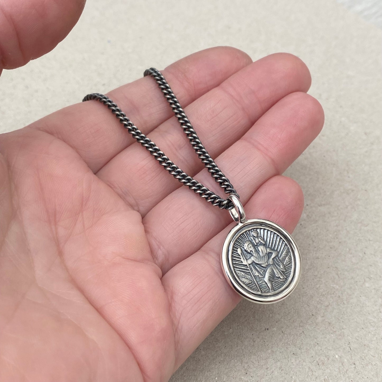 Oxidised solid silver Saint Christopher circle framed pendant on a close curb chain