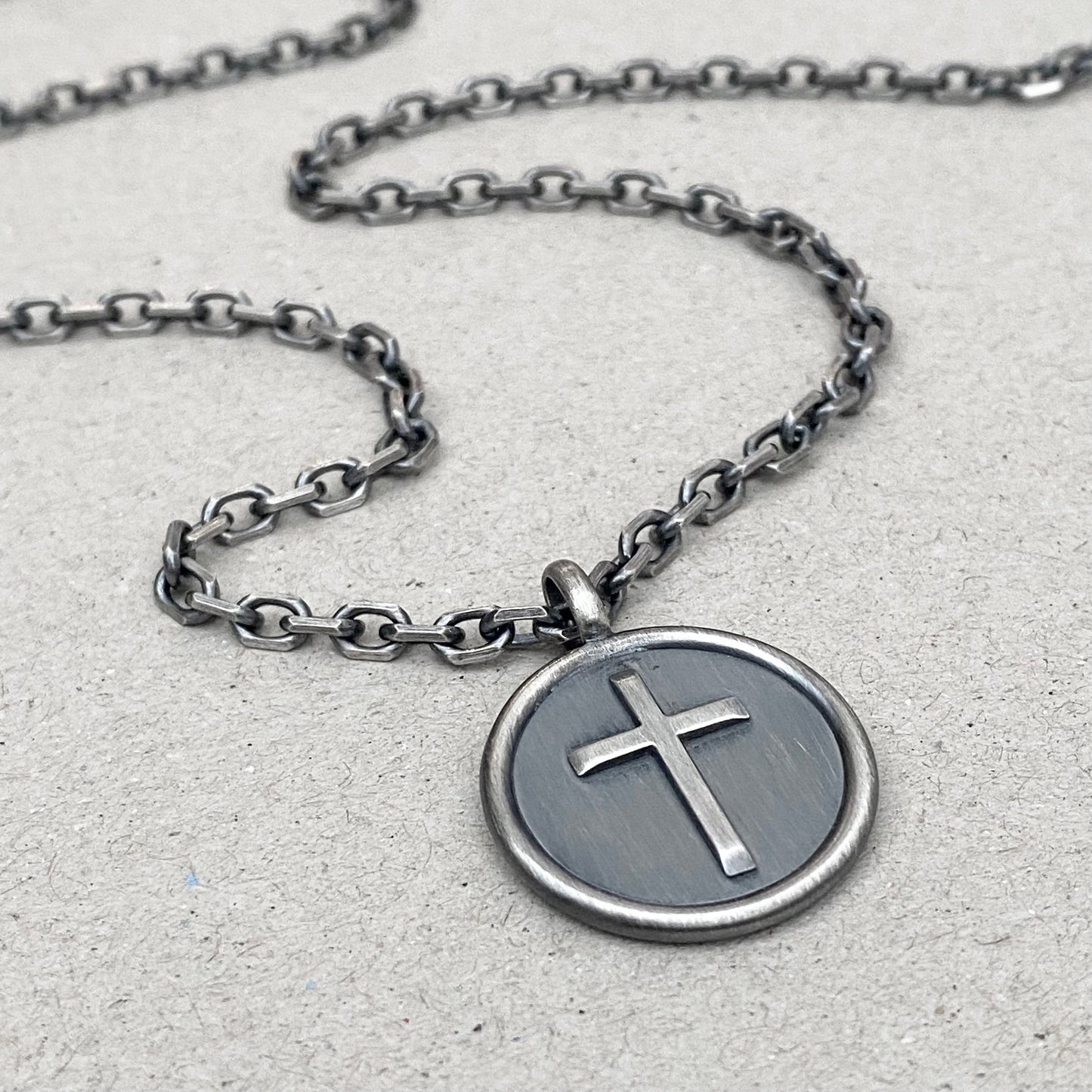 Oxidised solid sterling silver framed circle cross pendant on a diamond cut trace chain