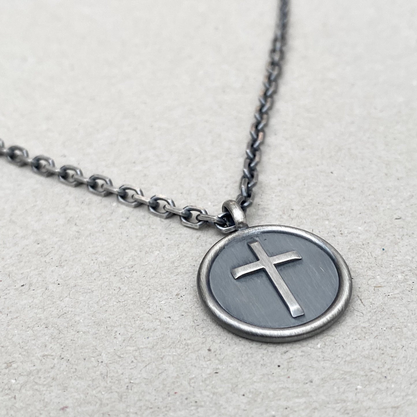 Oxidised solid sterling silver framed circle cross pendant on a diamond cut trace chain
