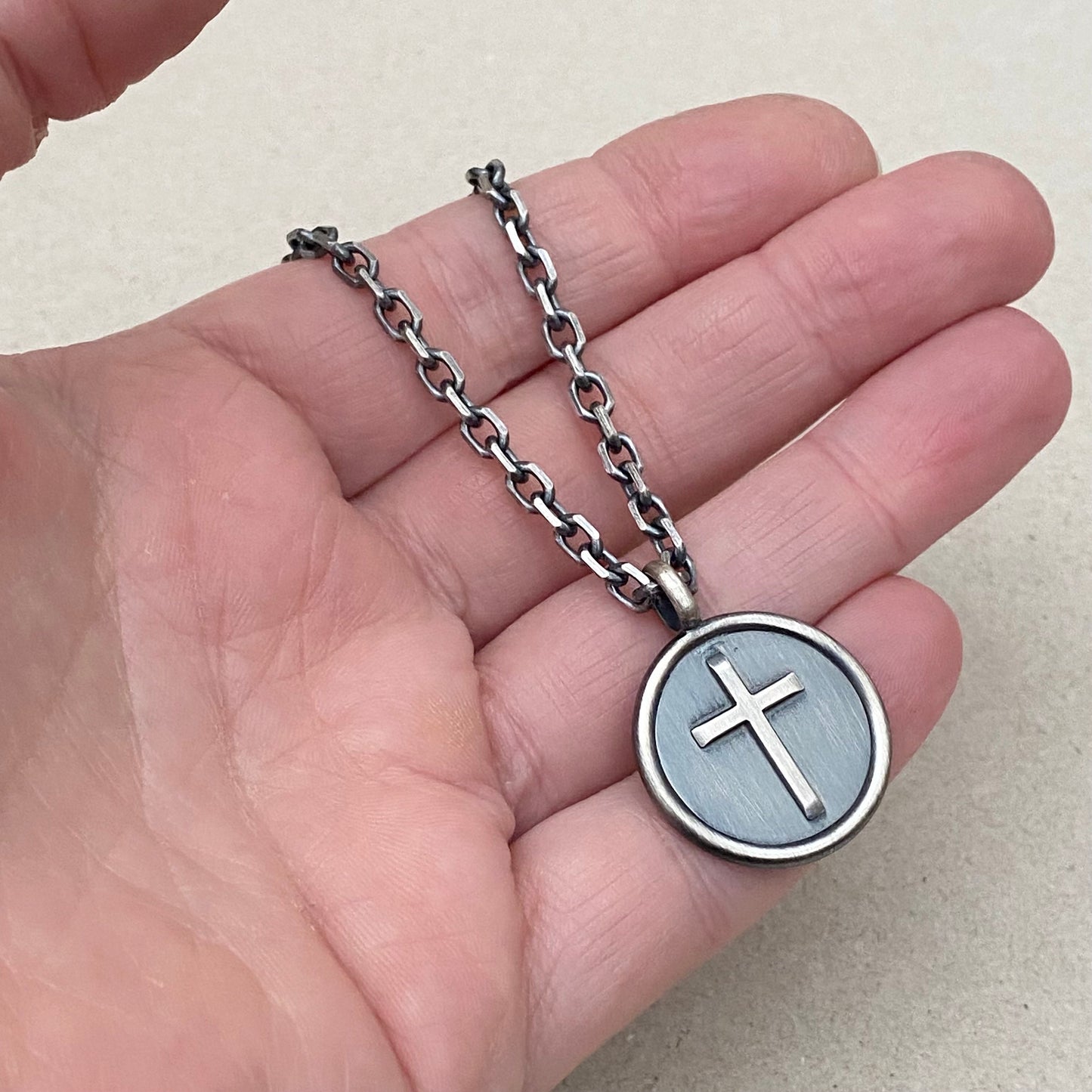 Oxidised solid sterling silver framed circle cross pendant on a diamond cut trace chain