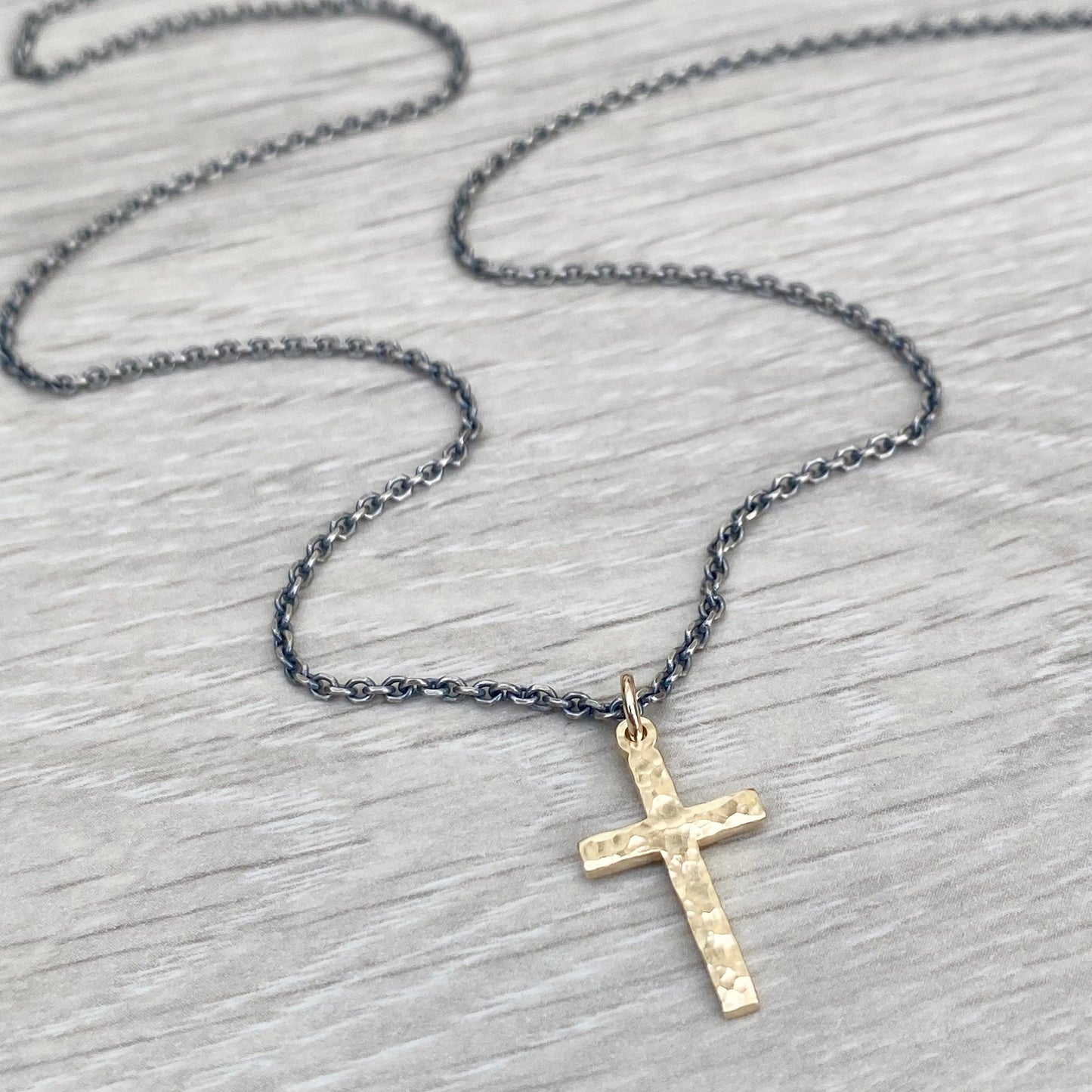 Polished small size 9ct yellow gold hammered cross pendant on a oxidised silver round box chain