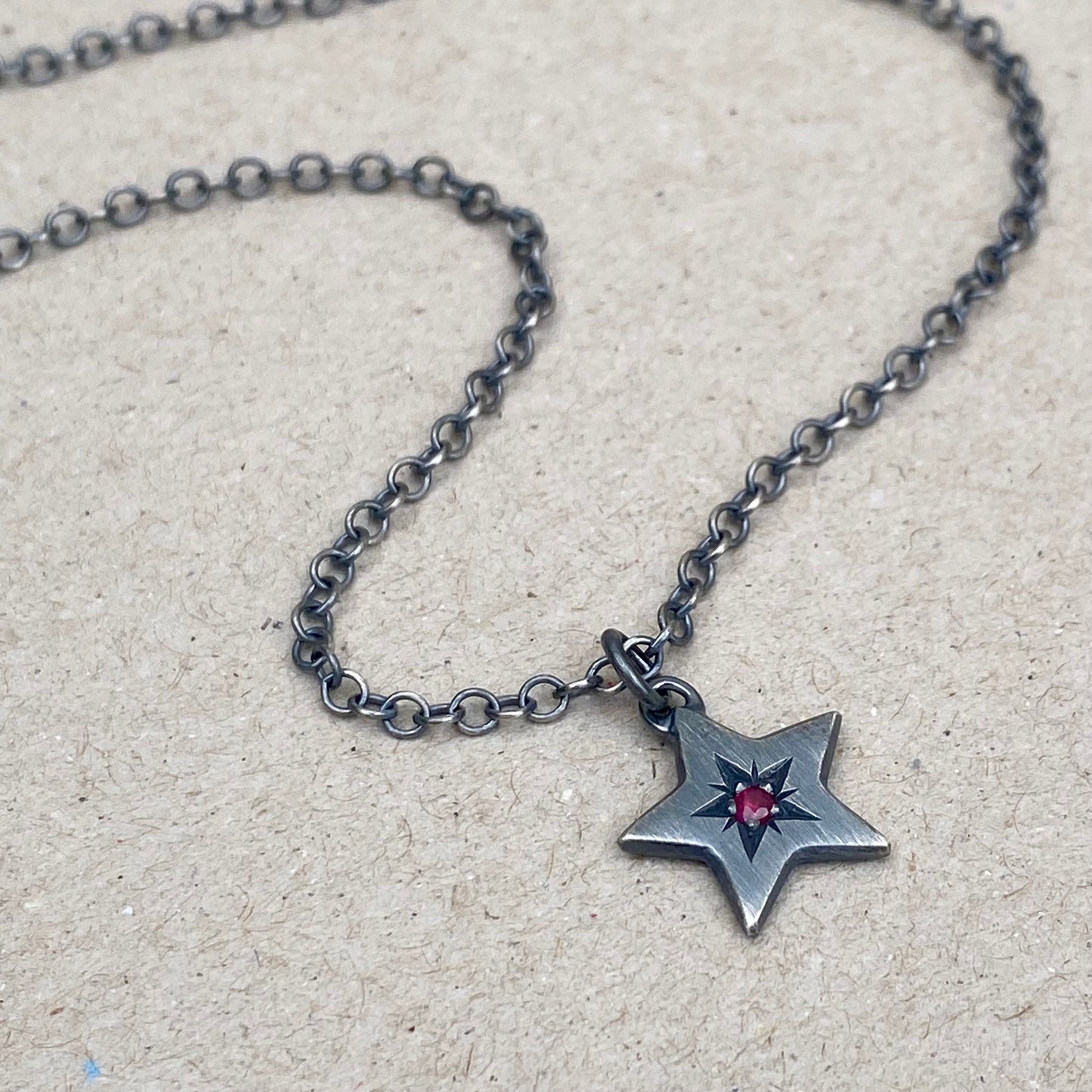 Oxidised silver star engraved birthstone star pendant on a trace chain