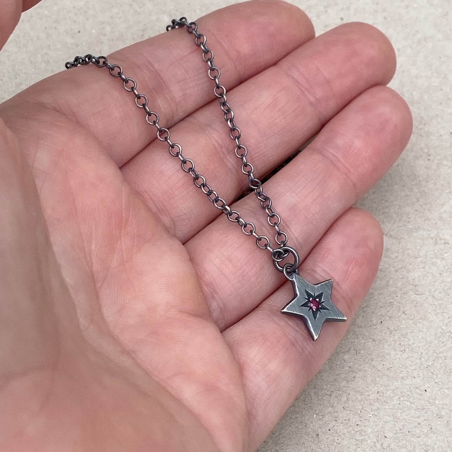 Oxidised silver star engraved birthstone star pendant on a trace chain