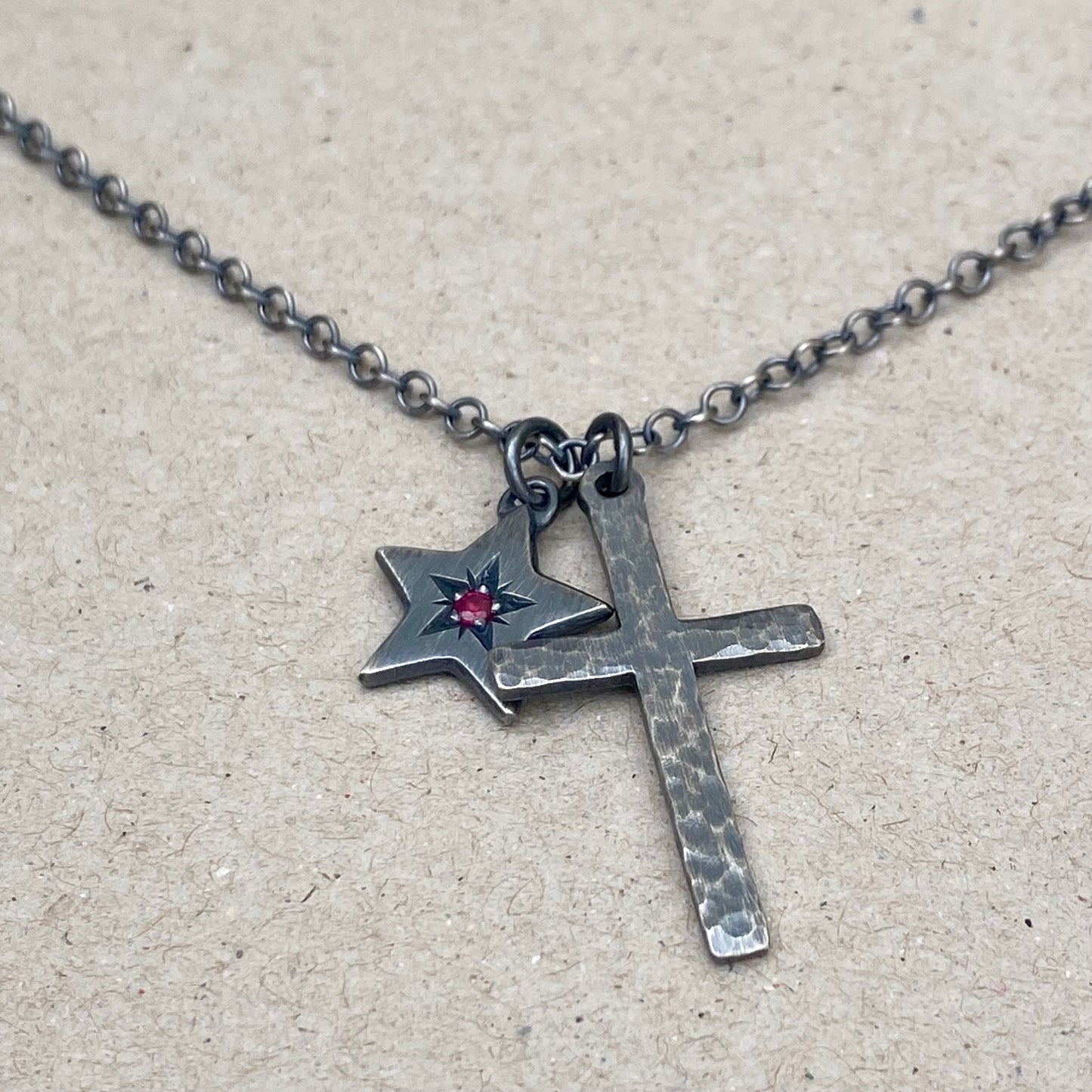 Oxidised silver star engraved birthstone star pendant and hammered cross on a trace chain