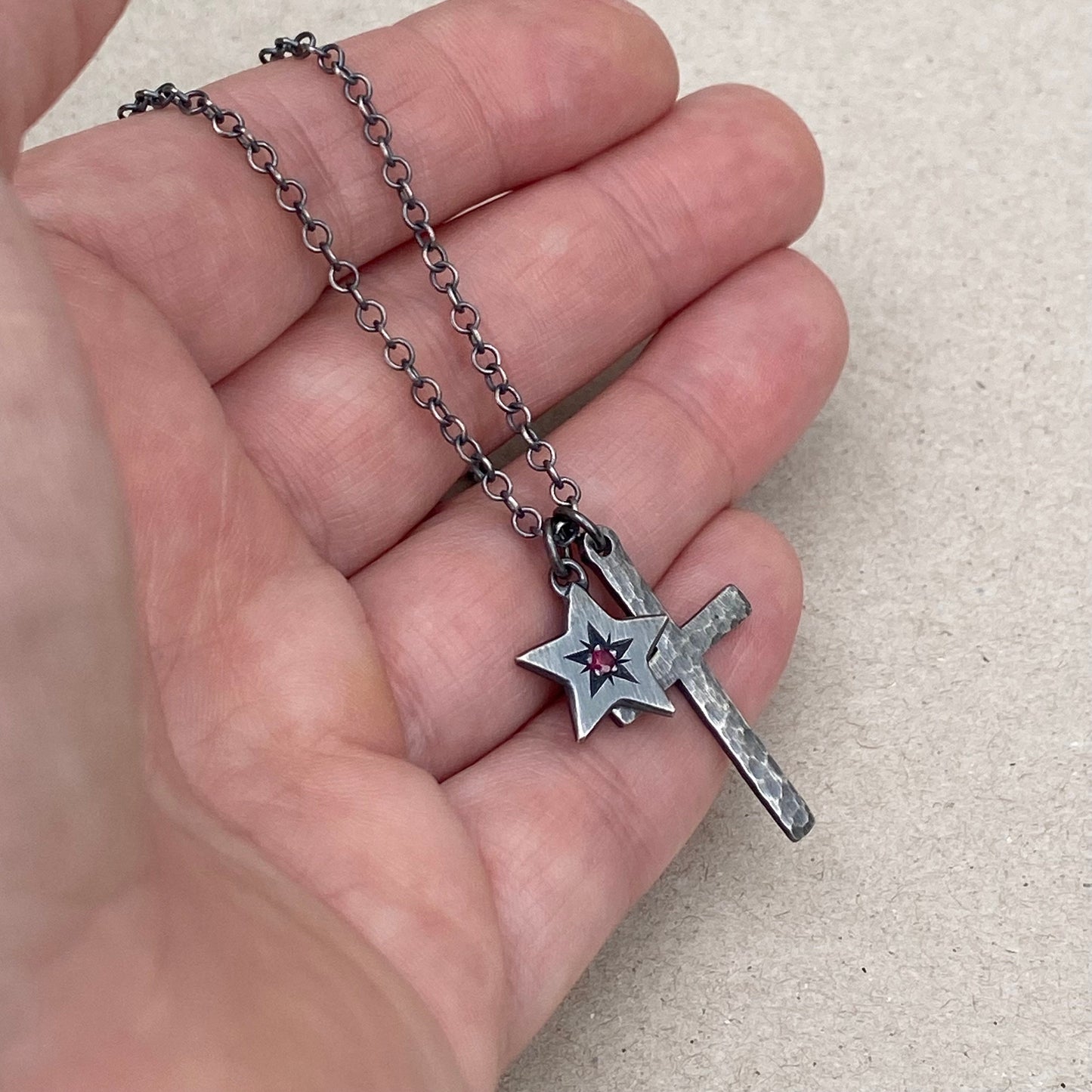Oxidised silver star engraved birthstone star pendant and hammered cross on a trace chain