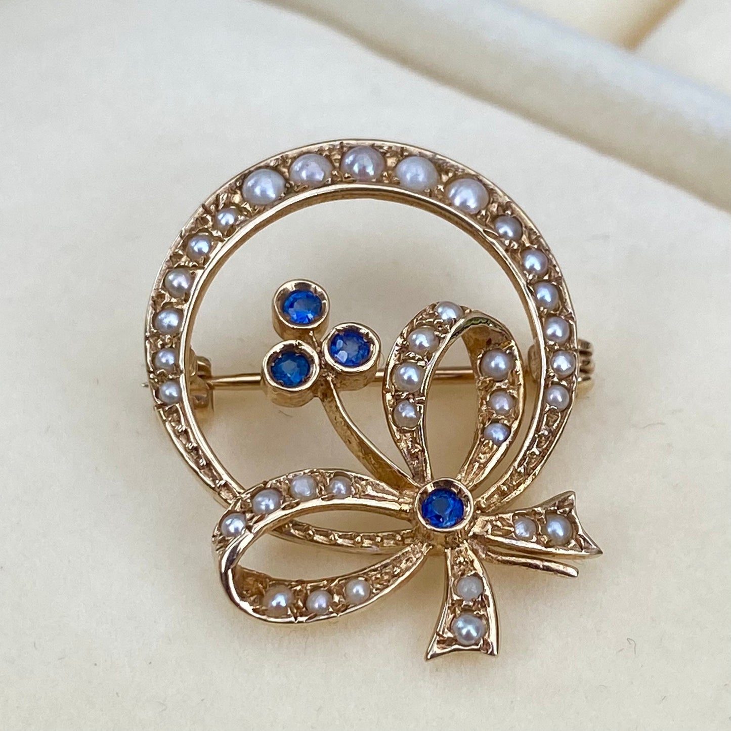 Vintage 9ct yellow gold seed pearl and blue sapphire flower, bow and crescent design brooch