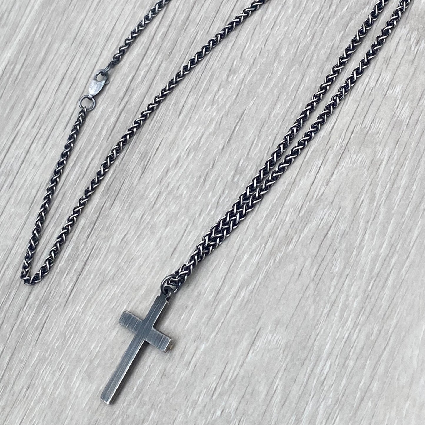 Oxidised solid silver and hammered 9ct yellow gold medium cross pendant on an oxidised silver spiga chain