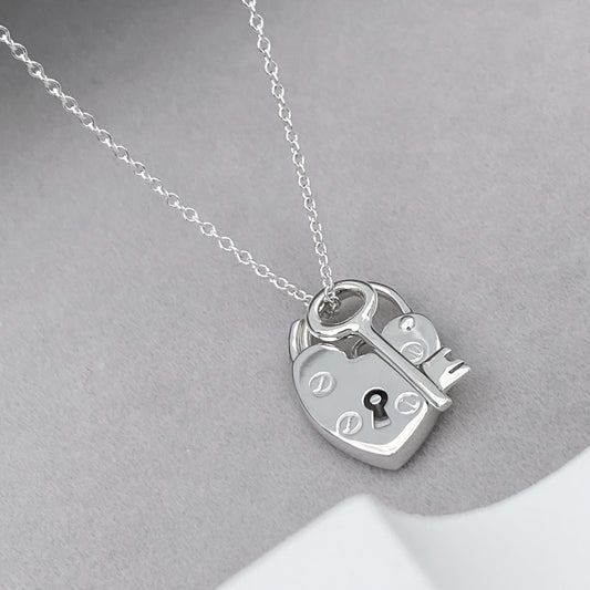 Solid silver heart padlock and dainty key charm pendant on a trace chain