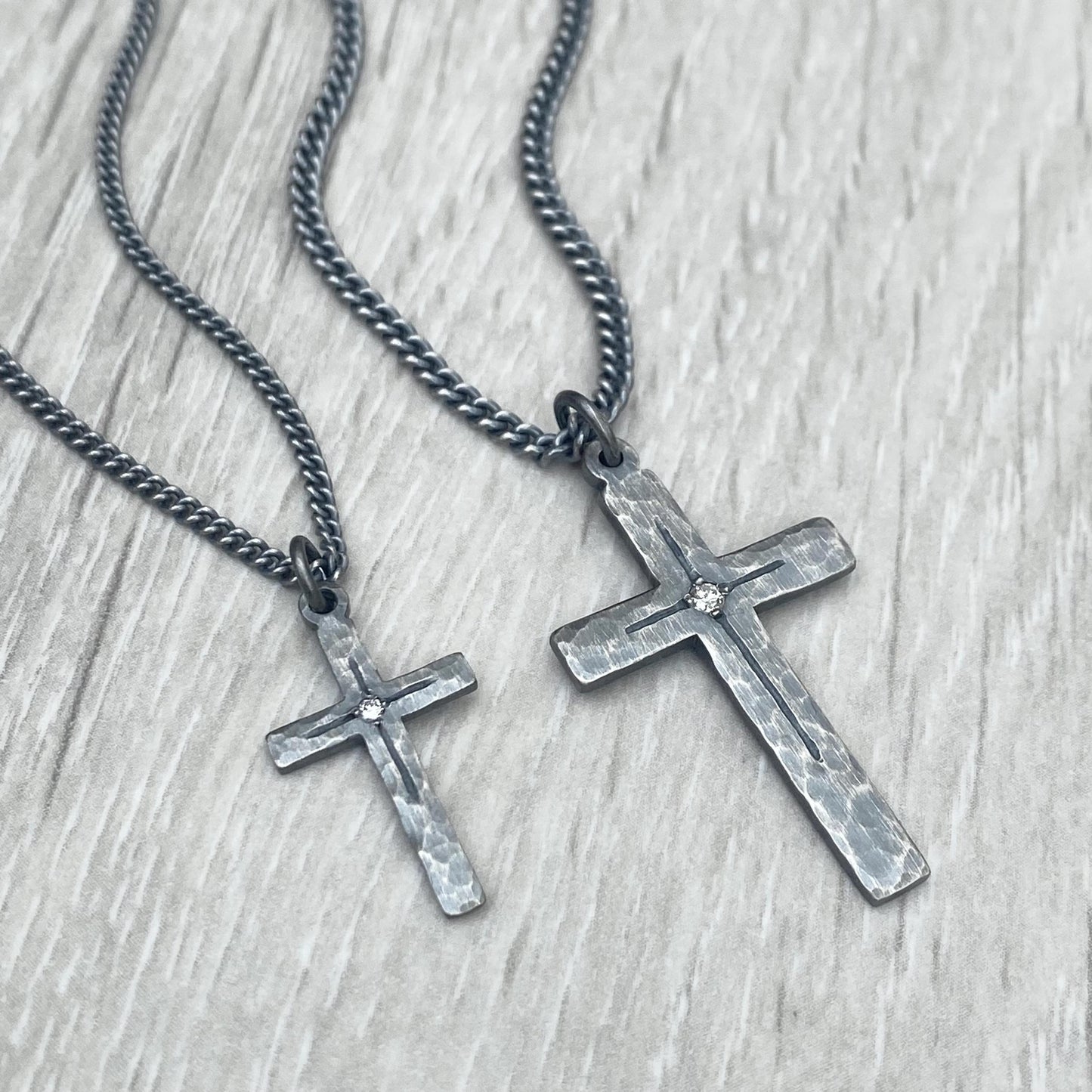 Oxidised solid sterling silver small or medium size diamond set cross pendants on a tight curb chain