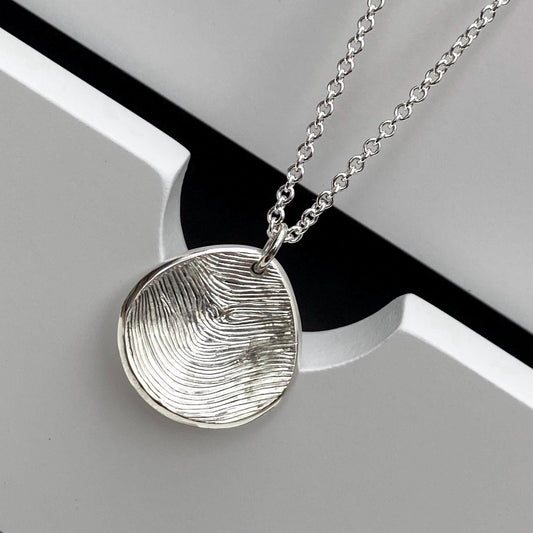 Handmade solid silver 16mm fingerprint petal charm pendant on a trace chain