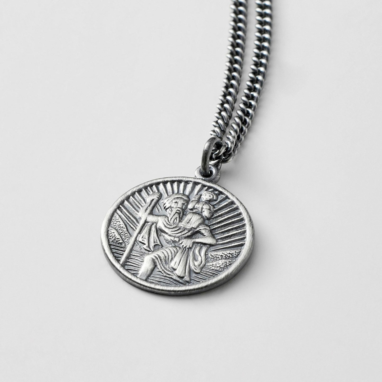 Oxidised or polished solid silver round Saint Christopher pendant on a curb chain