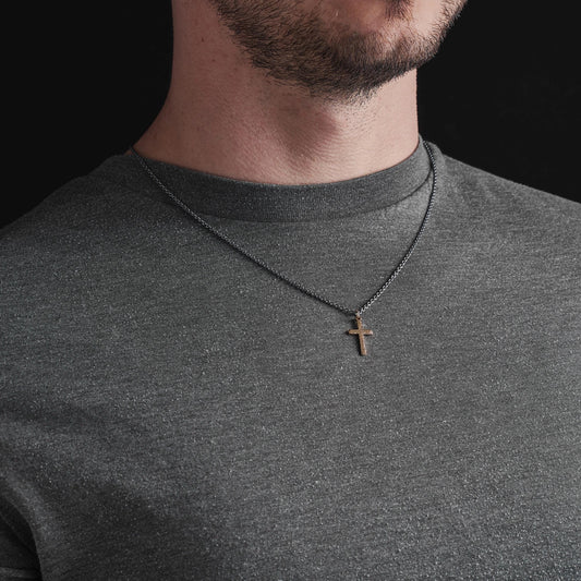 Polished small size 9ct yellow gold hammered cross pendant on a oxidised silver round box chain