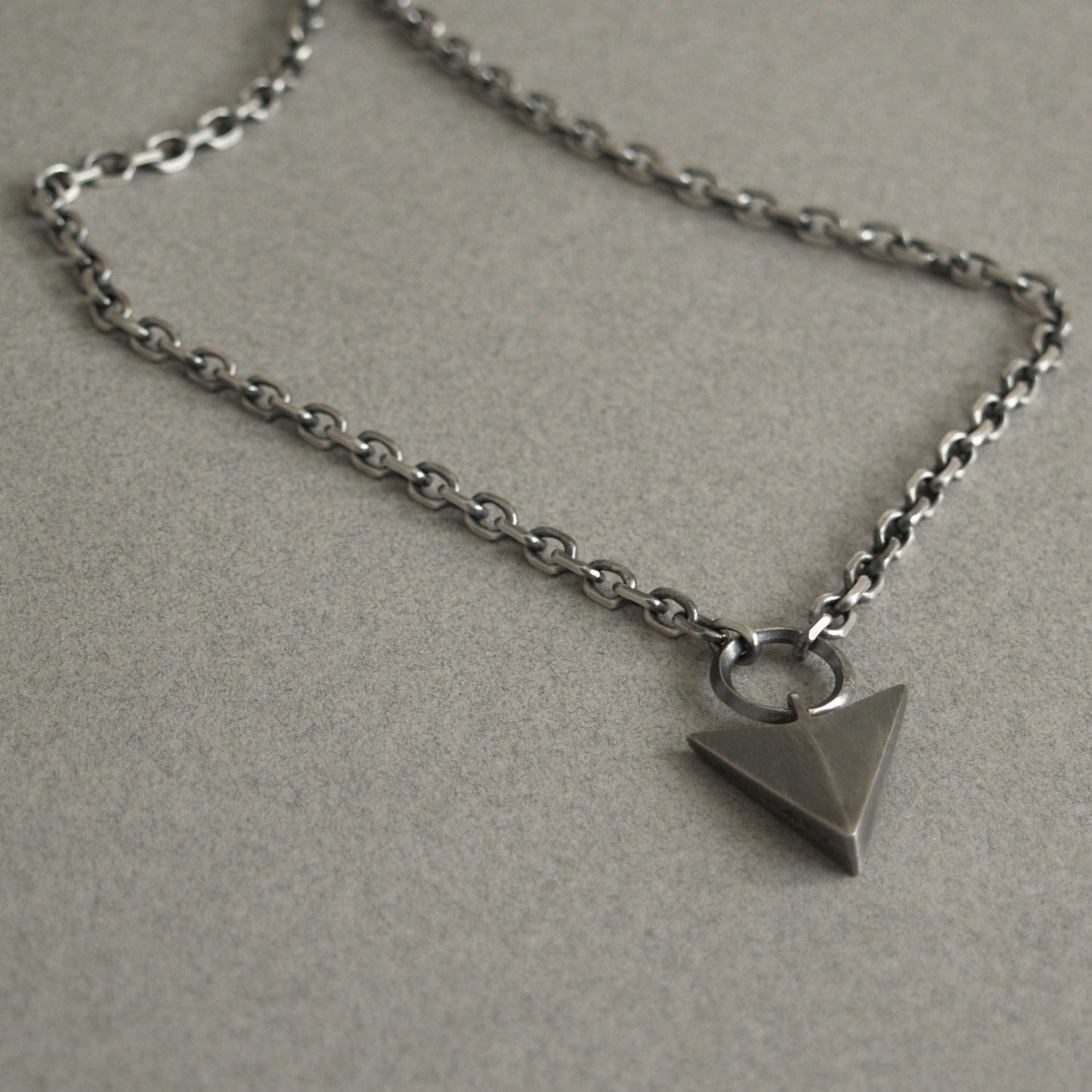 Oxidised or polished solid sterling silver large arrow and loop detail pendant on a diamond cut trace chain