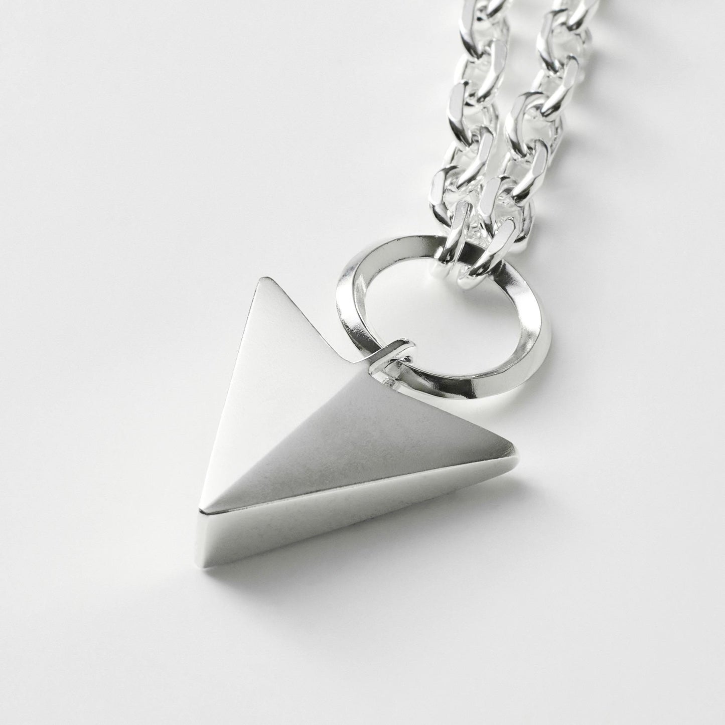 Oxidised or polished solid sterling silver large arrow and loop detail pendant on a diamond cut trace chain