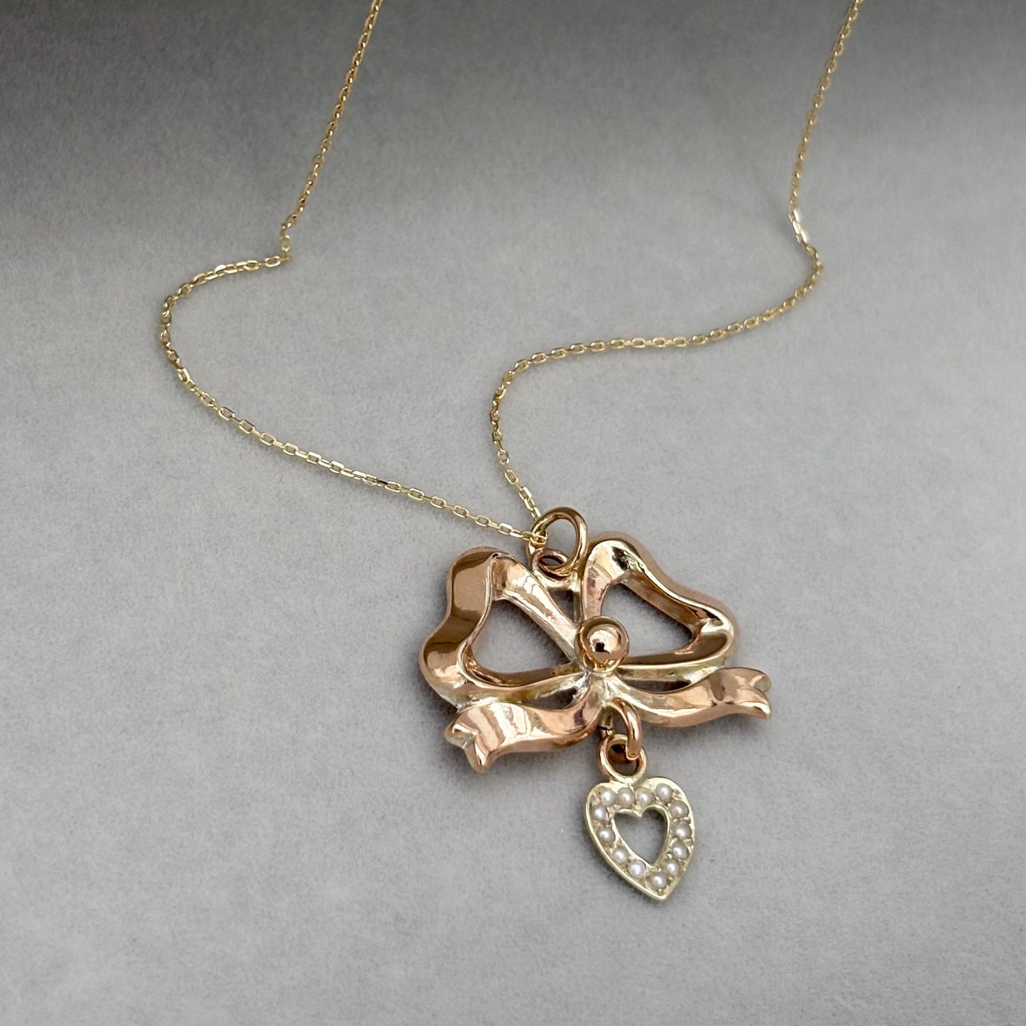 Vintage 9ct rose gold ribbon bow and seed pearl heart pendant on a new fine 0.8mm 9ct yellow gold chain