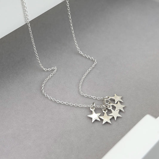 Sterling silver tiny star charm pendants on a trace chain